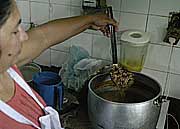 Paraguayan cook Clara Duarte preparing a bowl of jopara